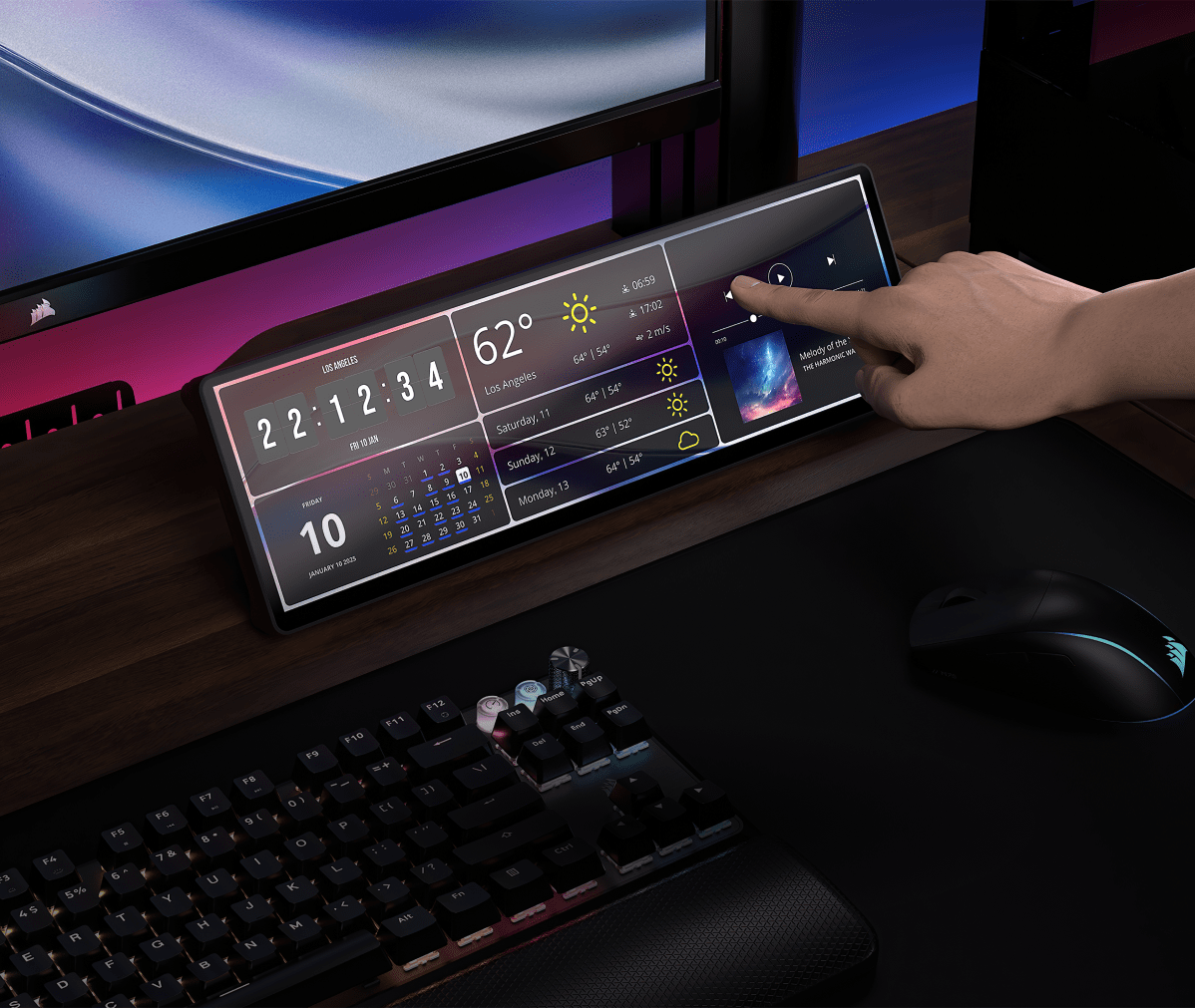 CORSAIR XENEON EDGE ultrawide touchscreen display showing widgets, being interacted with by a user on a gaming desk.