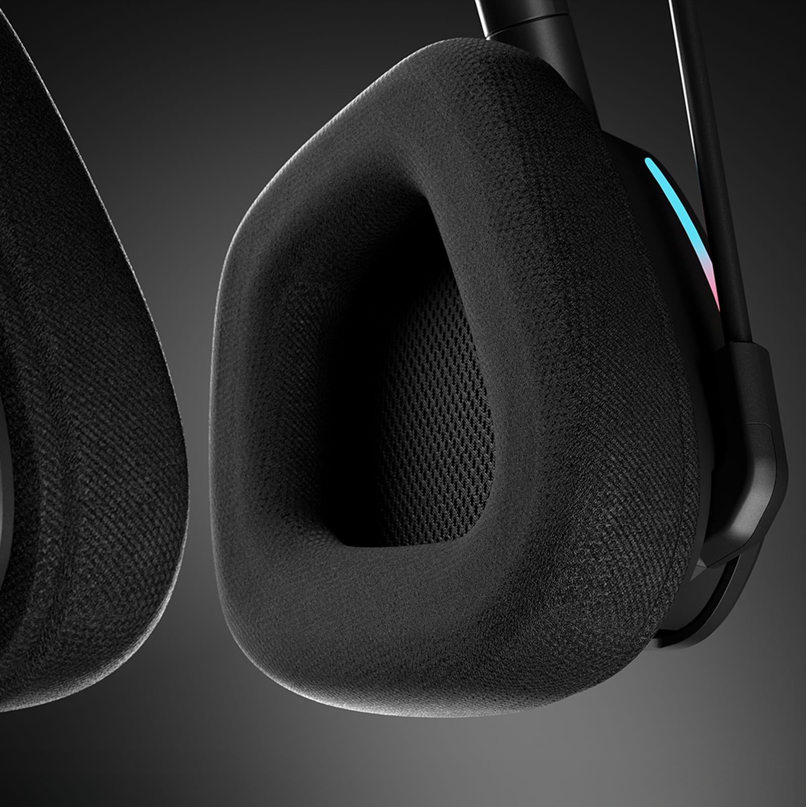 CORSAIR VOID v2 MAX wireless headset close-up of fabric mesh earcup cushion with blue RGB accent lighting.