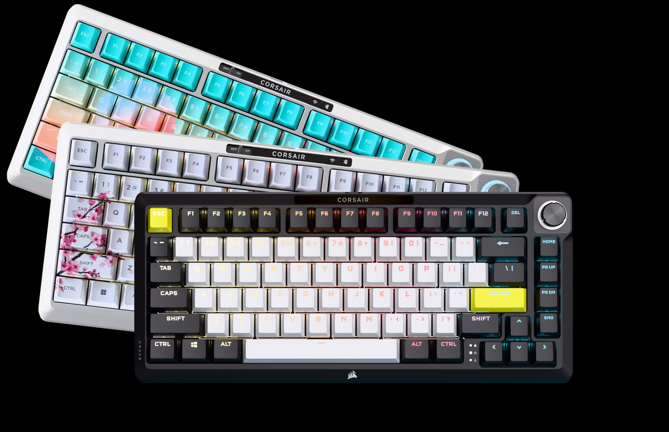 Three CORSAIR MAKR 75 wireless keyboards displayed on a black background in different colorways and keycap themes.