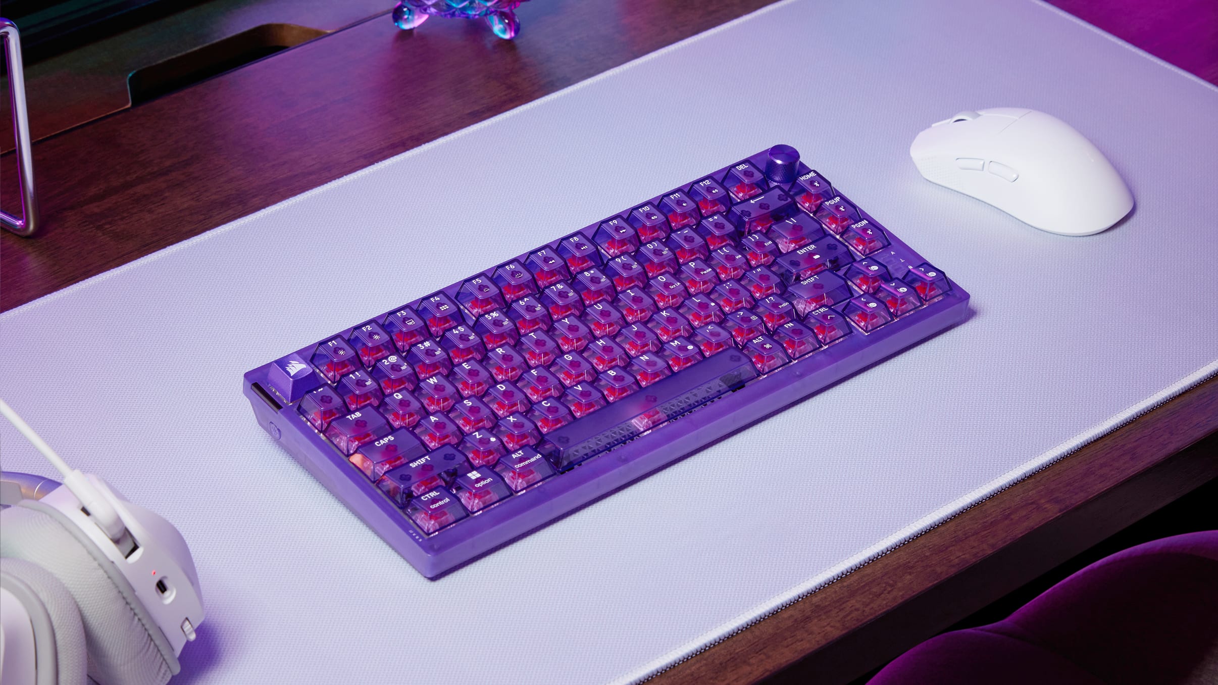 K65 PLUS Wireless keyboard in Atomic Purple with wired USB cable and white mouse, showing multi-connectivity options