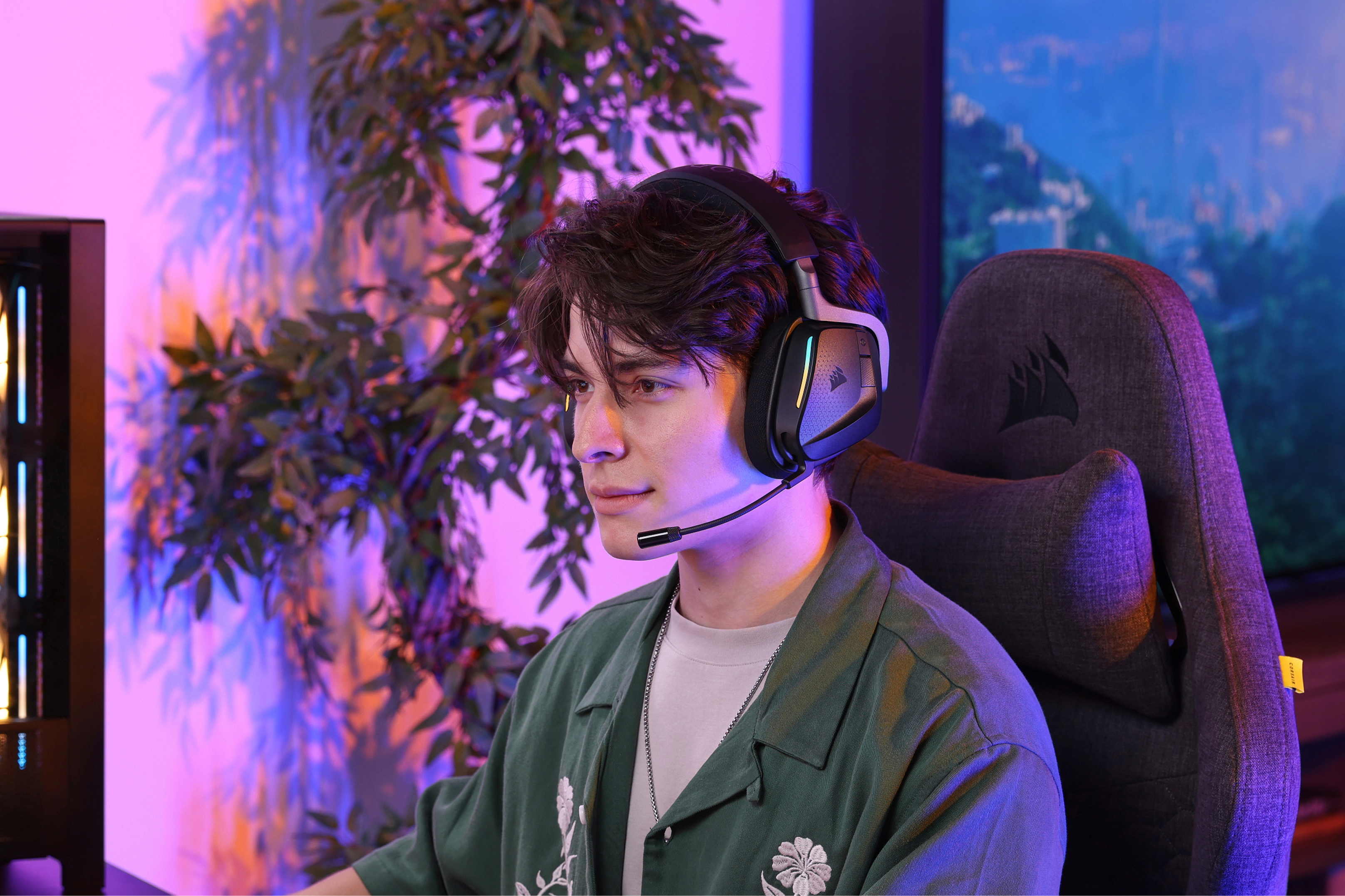 A gamer wearing the CORSAIR VOID v2 MAX wireless gaming headset with RGB lighting in a colorful gaming room.
