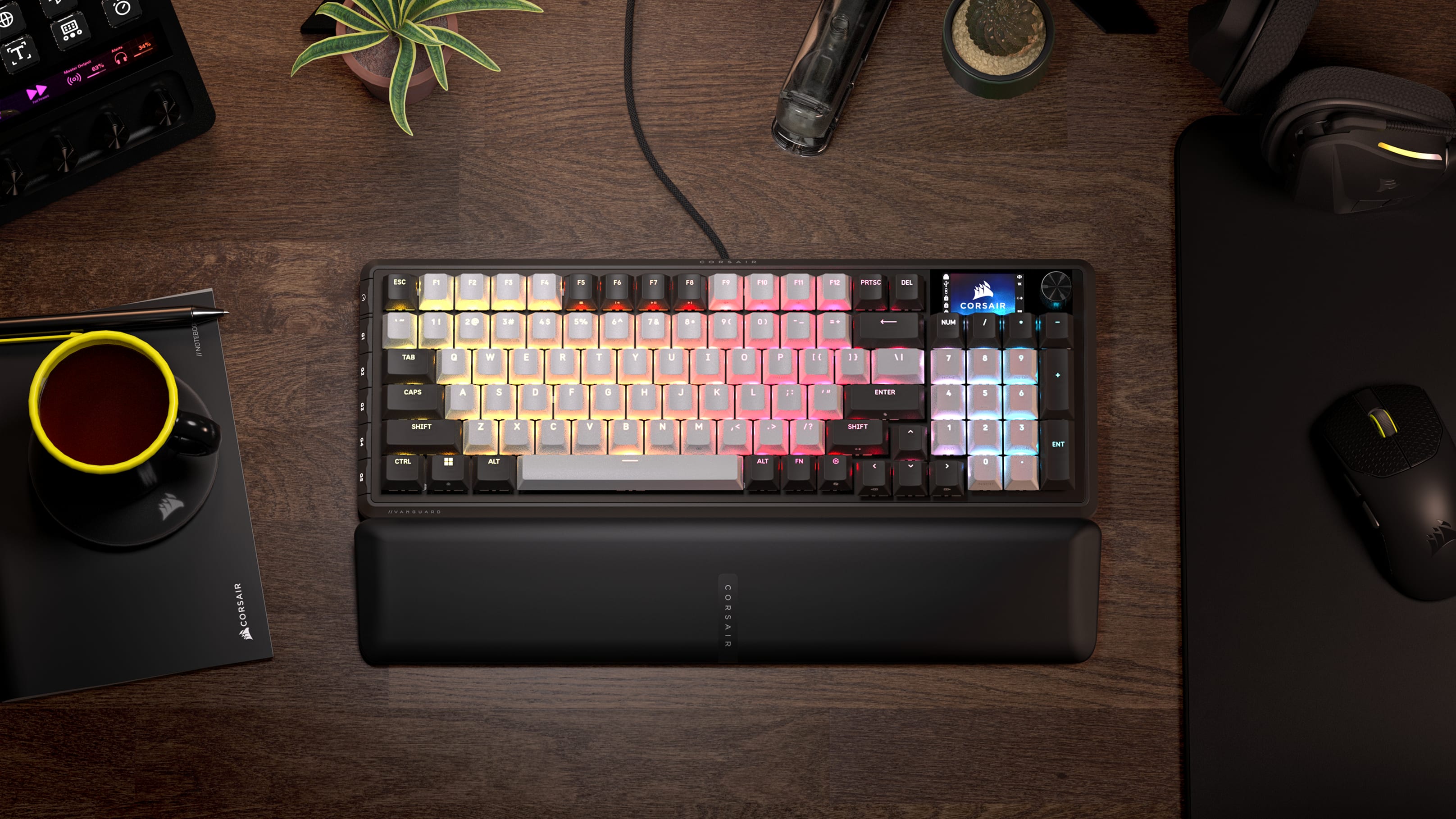 CORSAIR Vanguard 96 mechanical gaming keyboard with multicolor RGB lighting on a wooden desk with wrist rest.