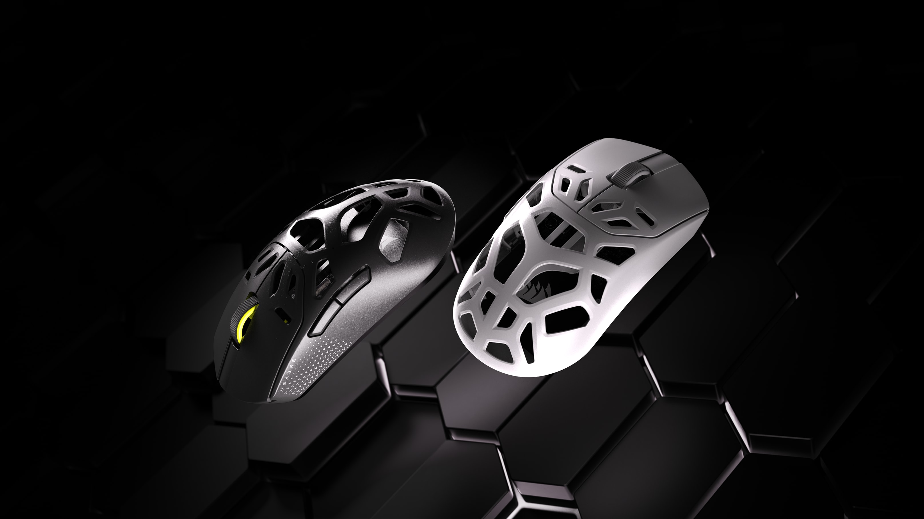 CORSAIR SABRE v2 WL MG gaming mice in black and white colorways showing the open-mesh magnesium ultra-lightweight chassis.