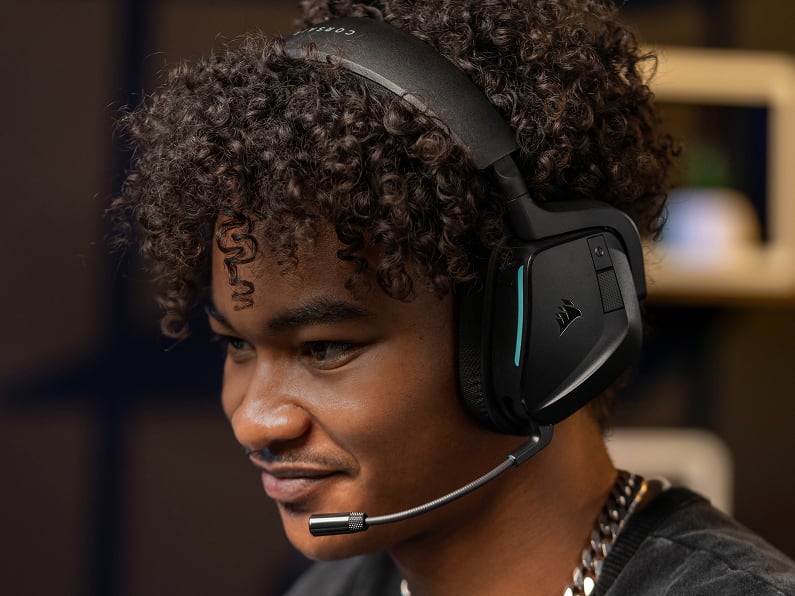 Person wearing a CORSAIR REVIVAL series gaming headset in a lifestyle shot highlighting teal LED accent and sleek design.