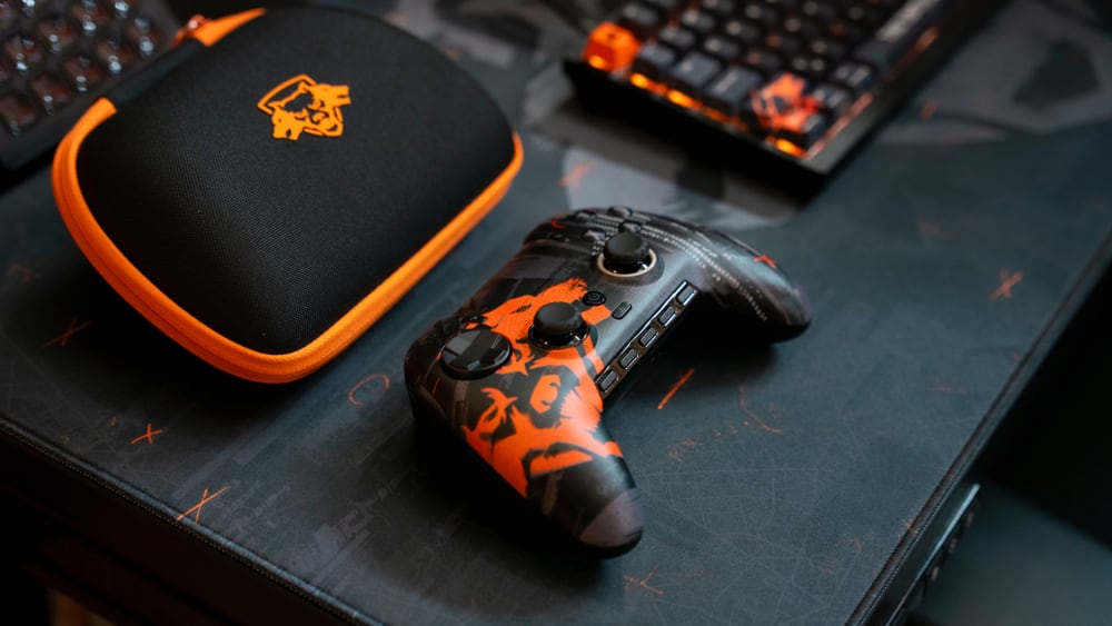 A Call of Duty® Black Ops 6 desktop corner, featuring the SCUF Envision Pro Wireless Gaming Controller (PC) (with case), CORSAIR K65 WIRELESS 75% RGB Mechanical Gaming Keyboard, and CORSAIR MM300 Gaming Mouse Mat—all in Call of Duty® Black Ops 6 Editions.