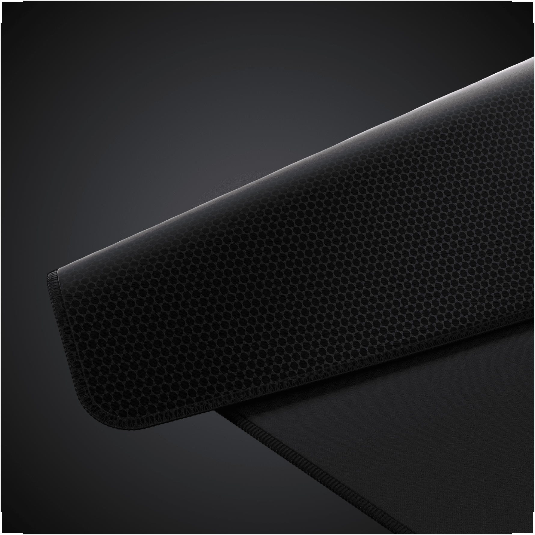 An image of the MM PRO CONTROL Desk Mat in black, folded to showcase its hex-patterned polyurethane base.
