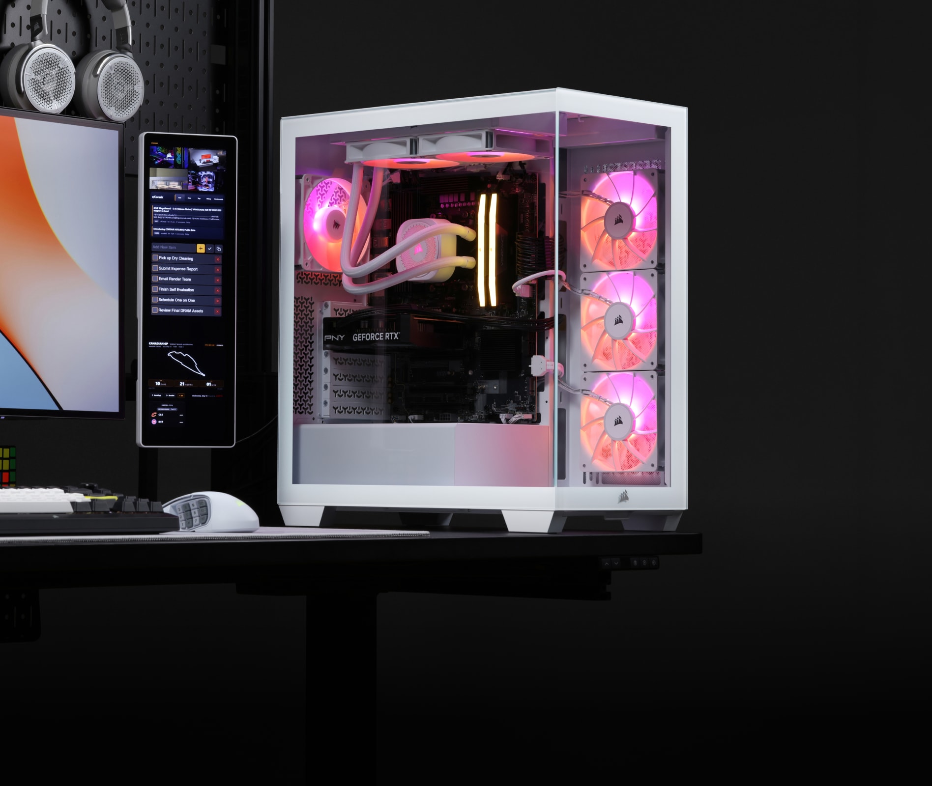 Corsair Vengeance a7500 gaming PC on a home desk with RGB lighting, AIO cooler, and case fans visible through the tempered glass panel.