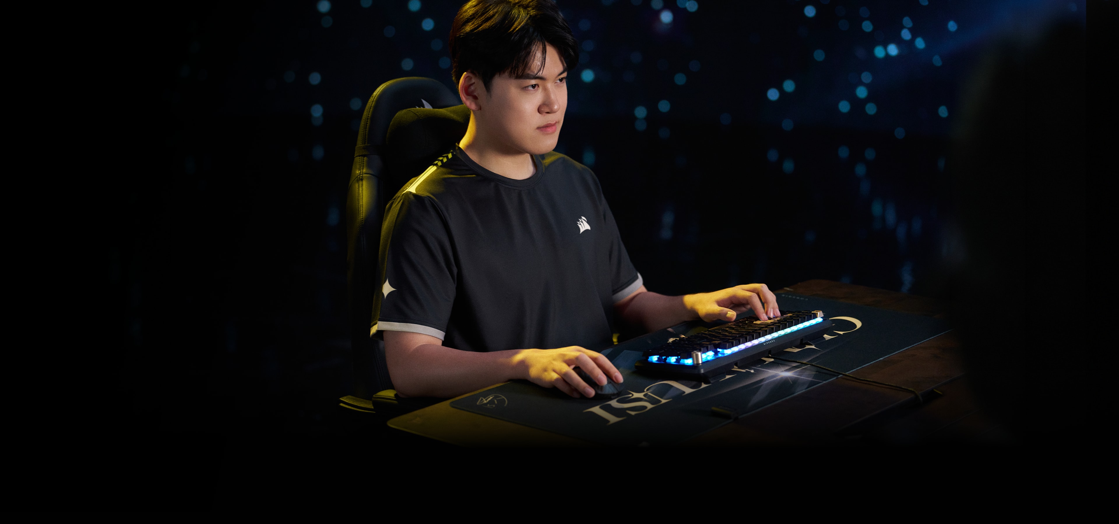Gumayusi, League of Legends pro player, focused at his gaming setup in a CORSAIR jersey in a neon-lit room