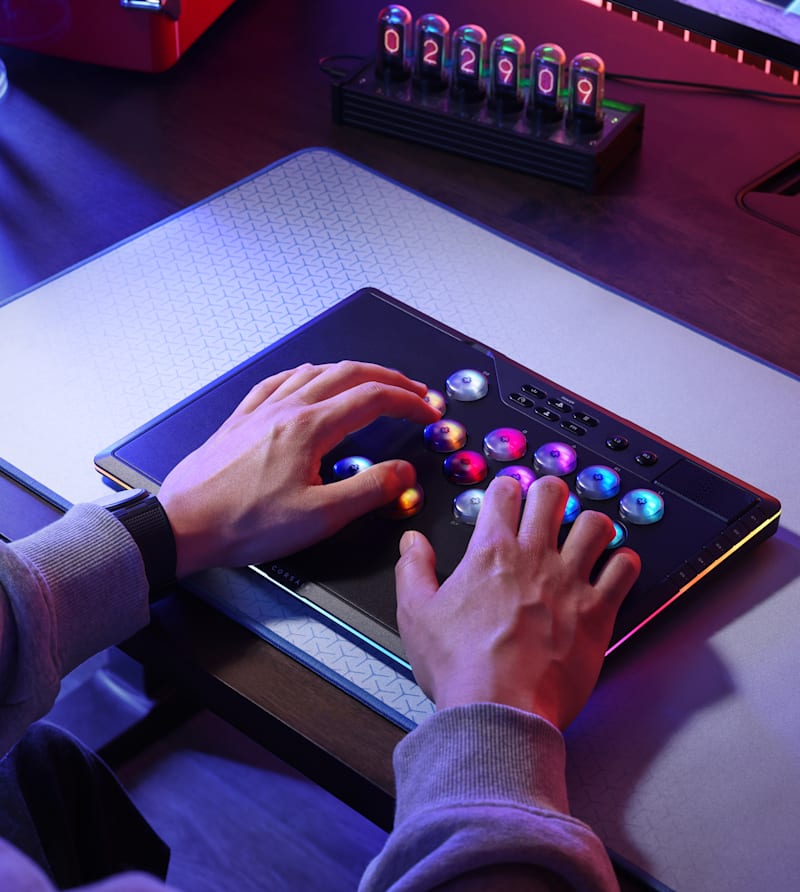 CORSAIR Novablade arcade fighting controller with RGB-illuminated buttons used in Game Mode on a desk.