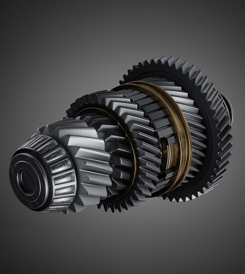 Rendered transmission gear assembly with helical gears and synchronizer rings.